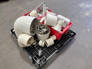 Assorted PVC pipe fittings and metal brackets