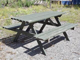Outdoor wooden picnic table with attached benches